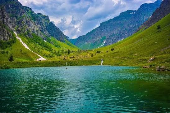 Alpine lake and green meadows in Minimarg Valley, Astore